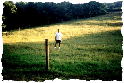 A picture of Lloyd Rieber literally standing in a field at his home.